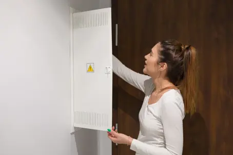 woman checking an electrical panel
