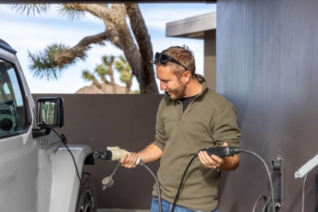 man holding Level 2 EV charger